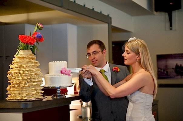 The bride and groom cutting the DIY wedding cake.
