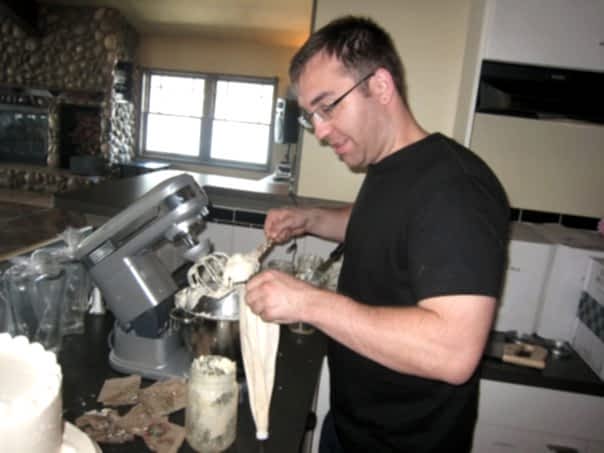 Man practicing making buttercream icing for a DIY wedding cake