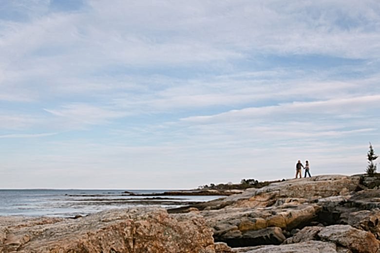 man and woman standing at the ocean
