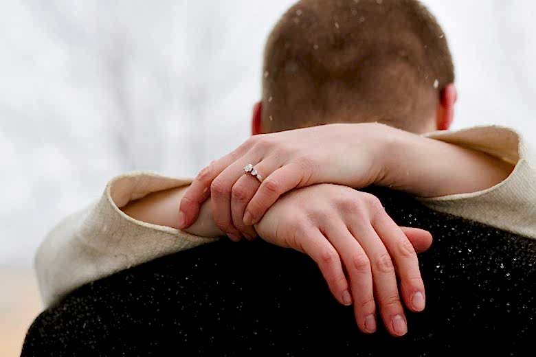 Woman and man kiss.