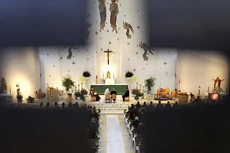 wedding viewed through a cross cutout