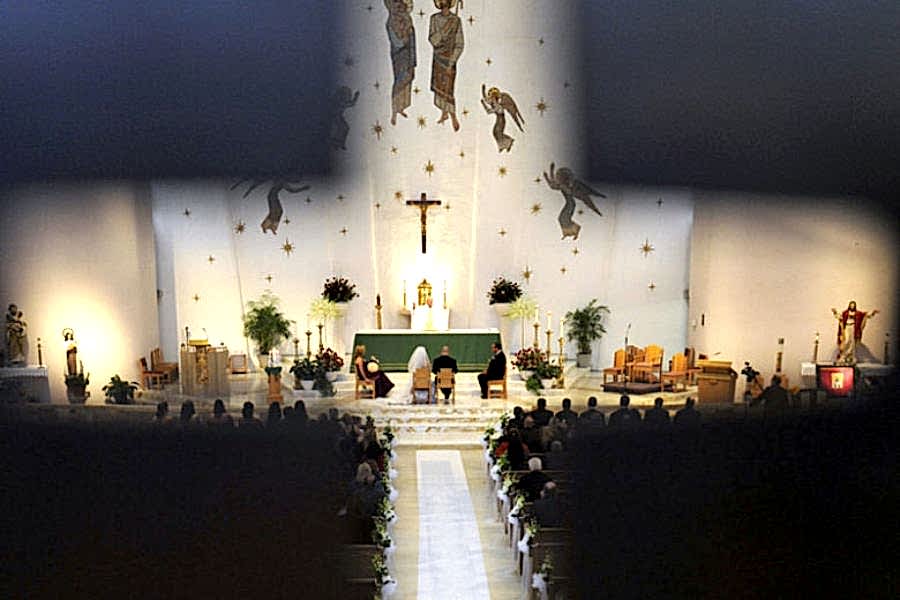 wedding viewed through a cross cutout