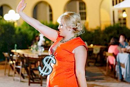 Woman dancing with a dollar sign around her neck