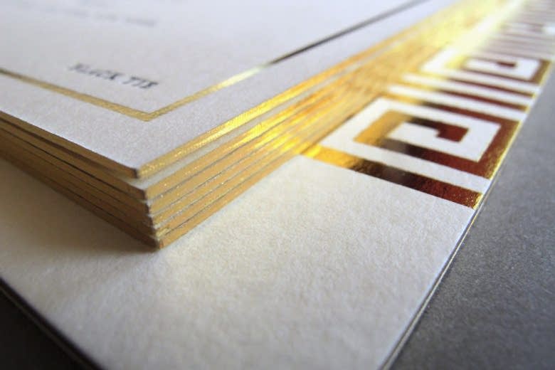 Close-up detail shot of gold-edged thick cardstock from letterpress printers Thomas Printers