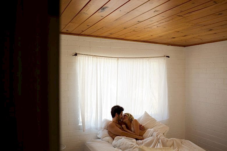 a couple lie in bed