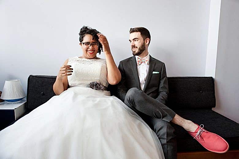 laughing bride sitting next to groom