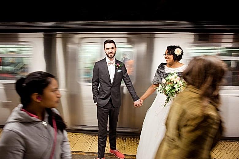 bride and groom in front of subway