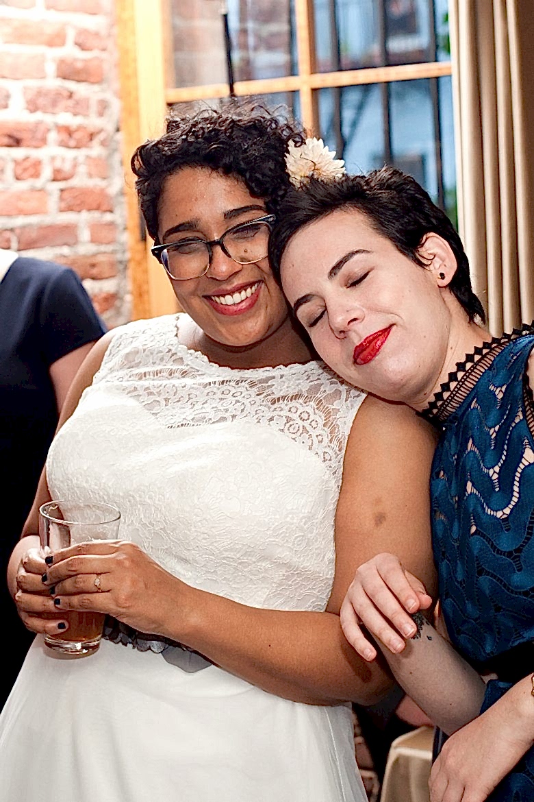 bride and friend at wedding reception