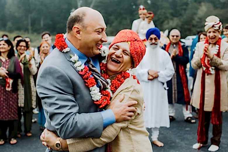two men embracing at a wedding