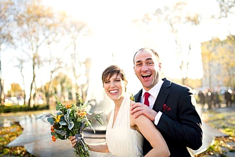 Smiling bride and groom in park