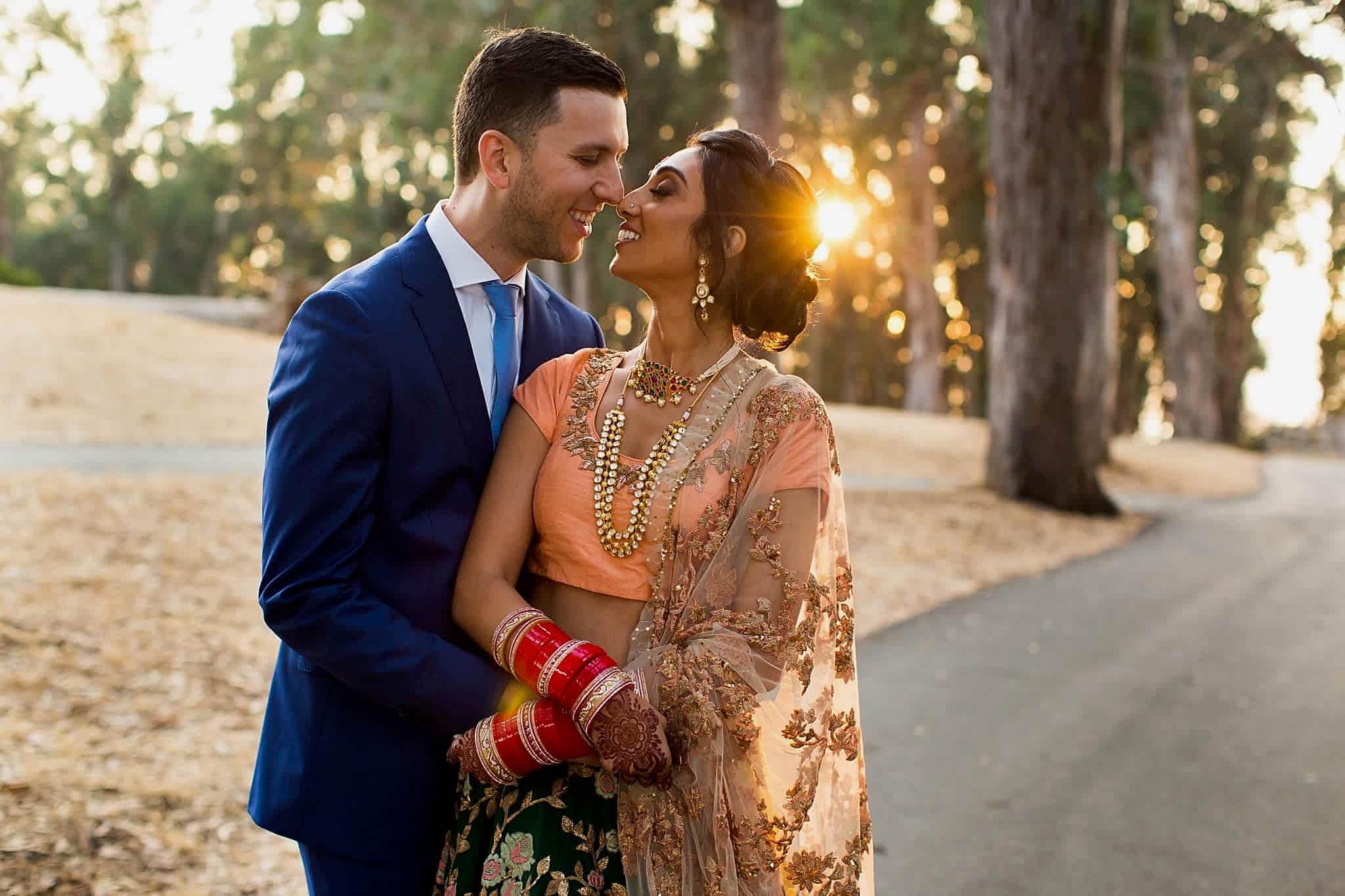 two people smile at sunset