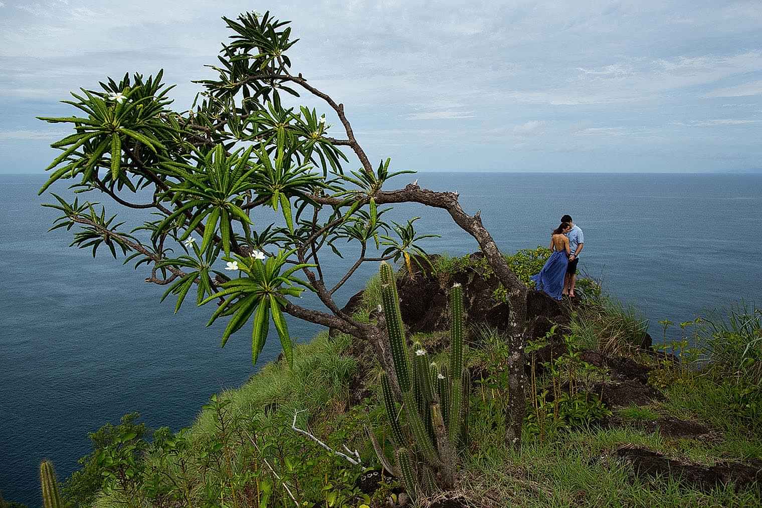 two people stand on a cliff