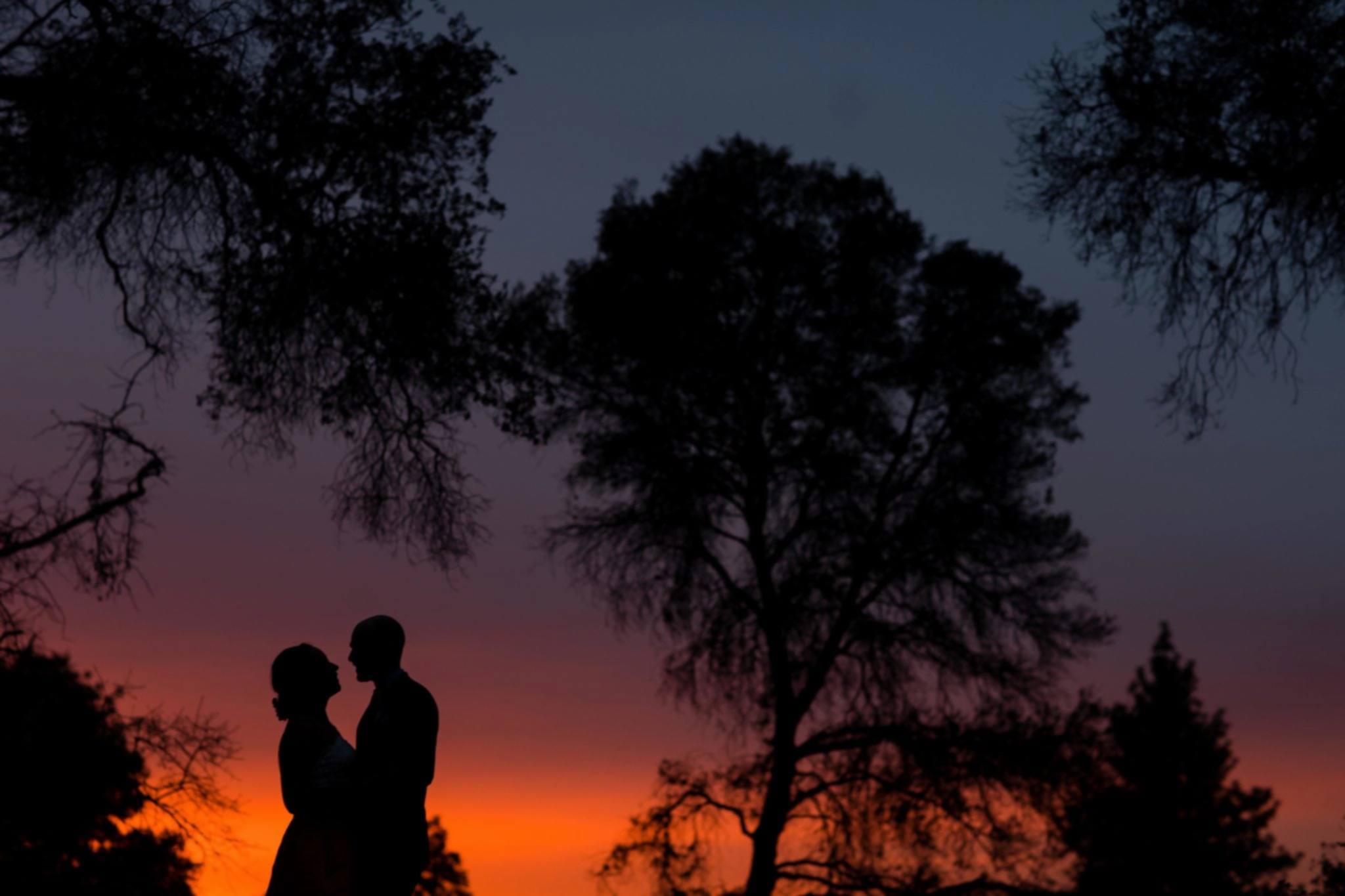 a man and woman at sunset