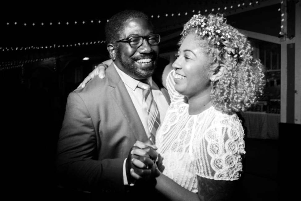 a bride and her father dance together