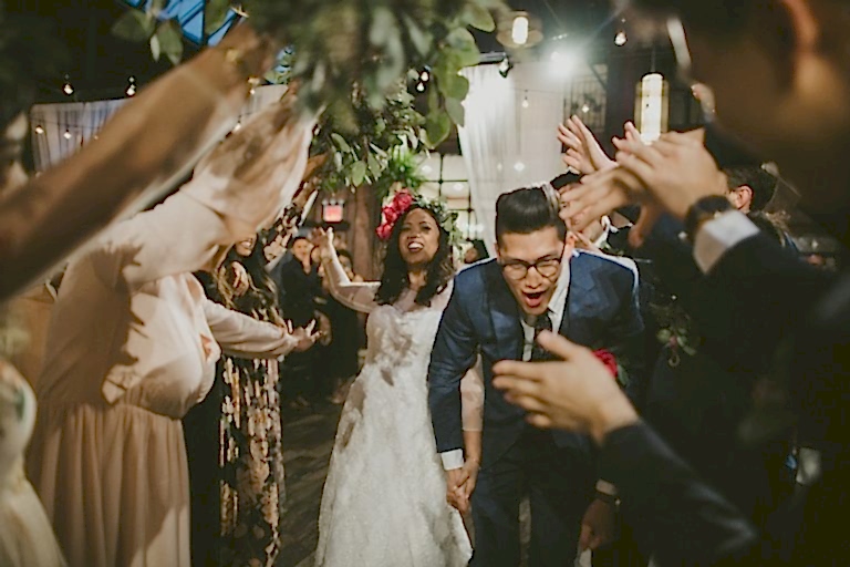 a bride and groom make their wedding exit