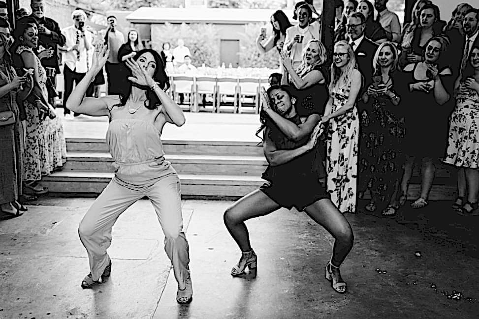 bridesmaids dancing while entering a reception