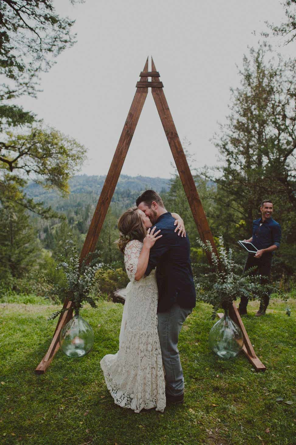a couple kiss during their wedding ceremony