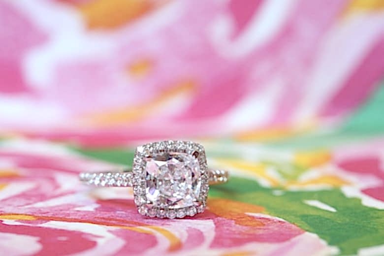Large halo diamond engagement ring on bright pattern backdrop