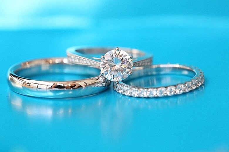 Stack of wedding rings on a blue background