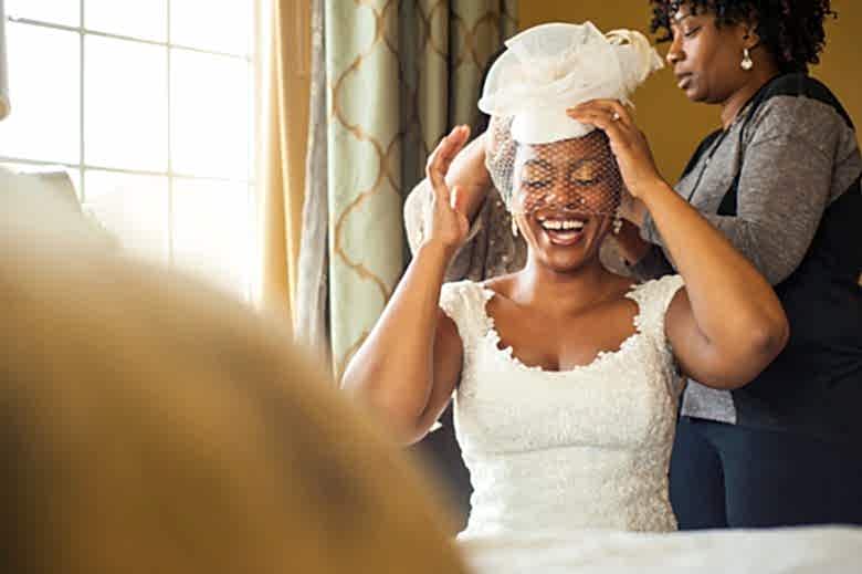 bride laughing while getting ready for her wedding