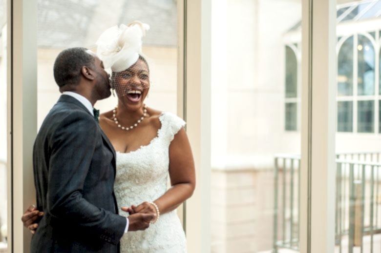 bride and groom laughing in wedding photo