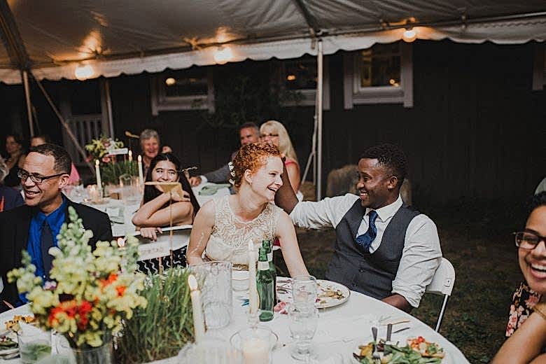 bride and groom laughing at wedding reception