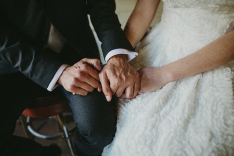 bride and groom holding hands