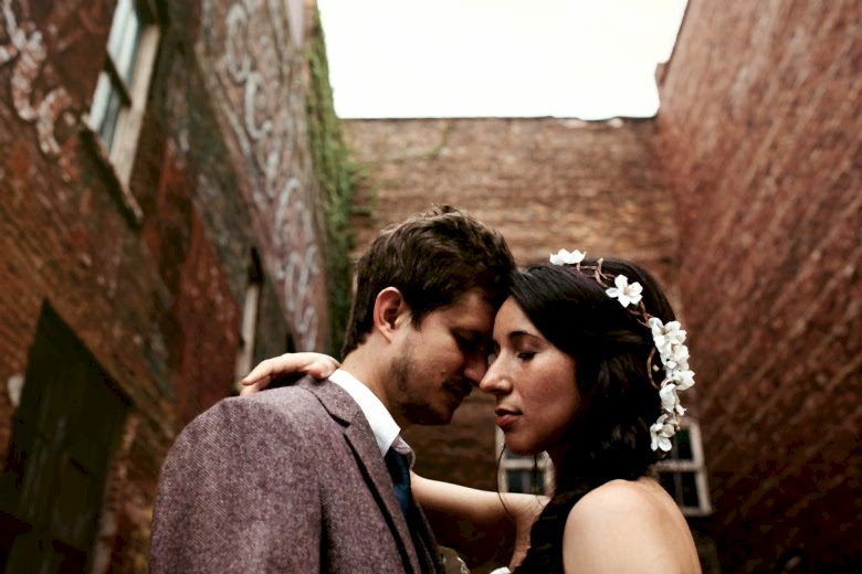 Bride and groom standing together outside