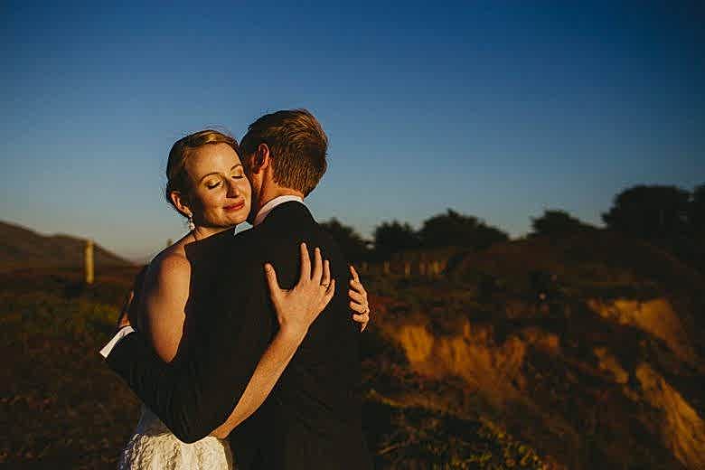 Bride and groom hugging one another