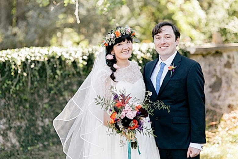 bride and groom standing together and smiling at camera