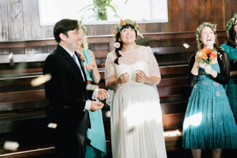 bride and groom standing in confetti