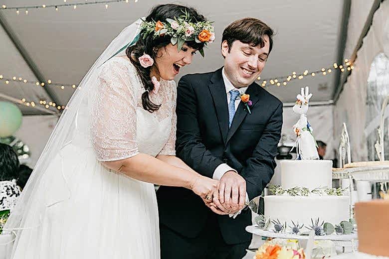 bride and groom cutting their wedding cake