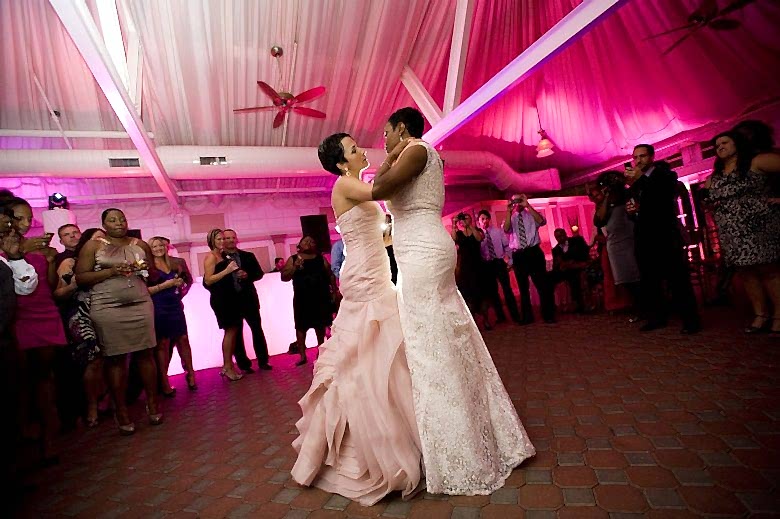 Two brides dancing together