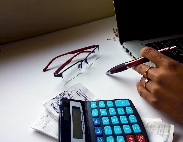 black woman at computer with calculator