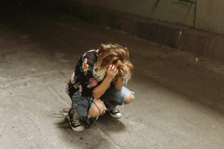 woman crouched down on the floor