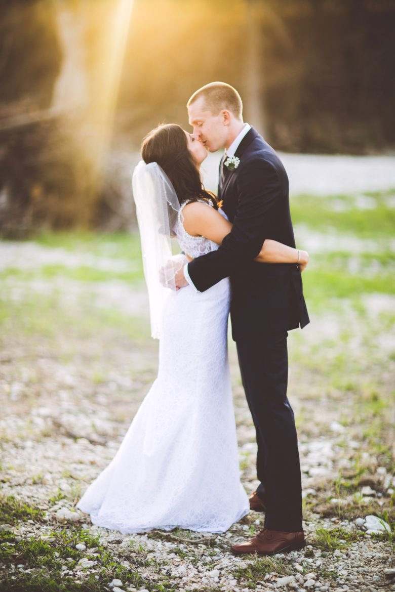 Photography by Kelley Raye couple kissing in a beam of sunlight