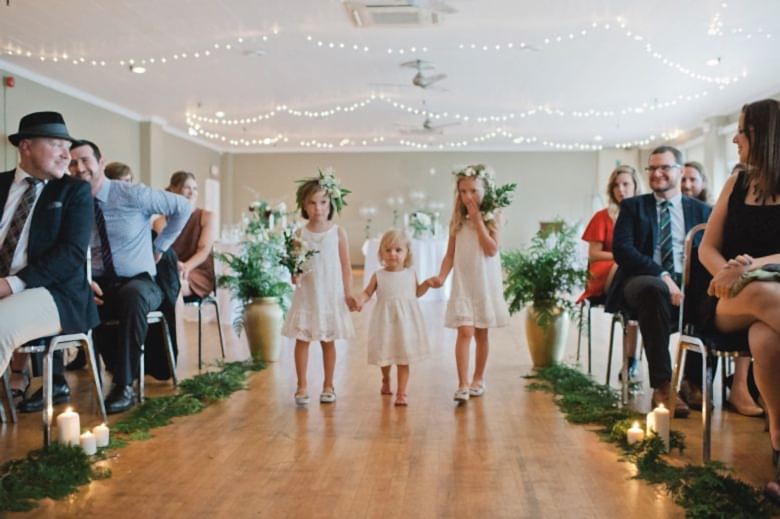 flower girls walking up wedding aisle