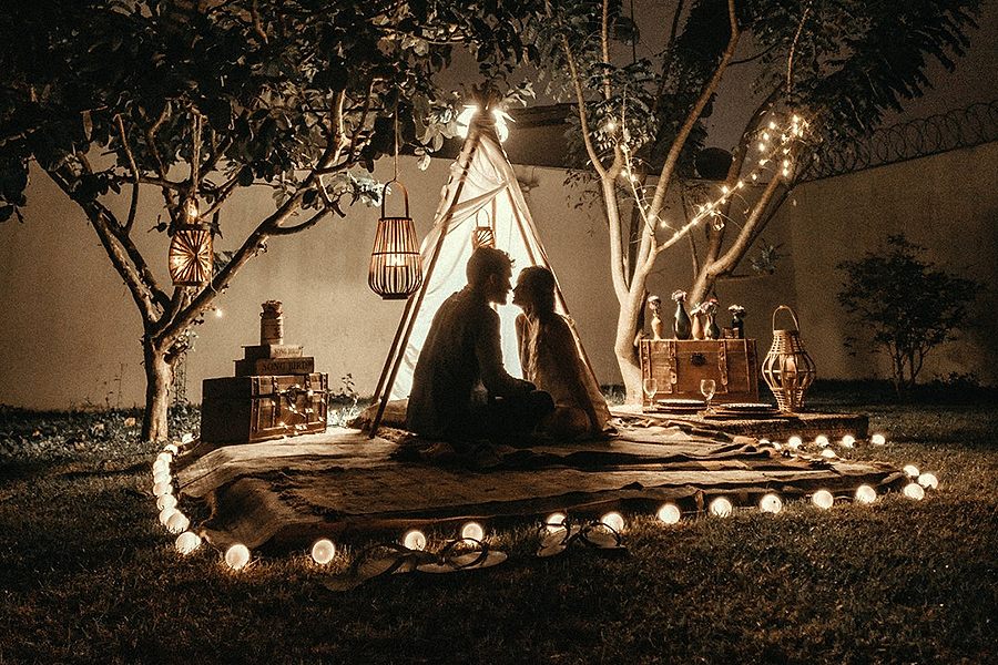 Two persons hanging out with a teepee indicating wedding appropriation