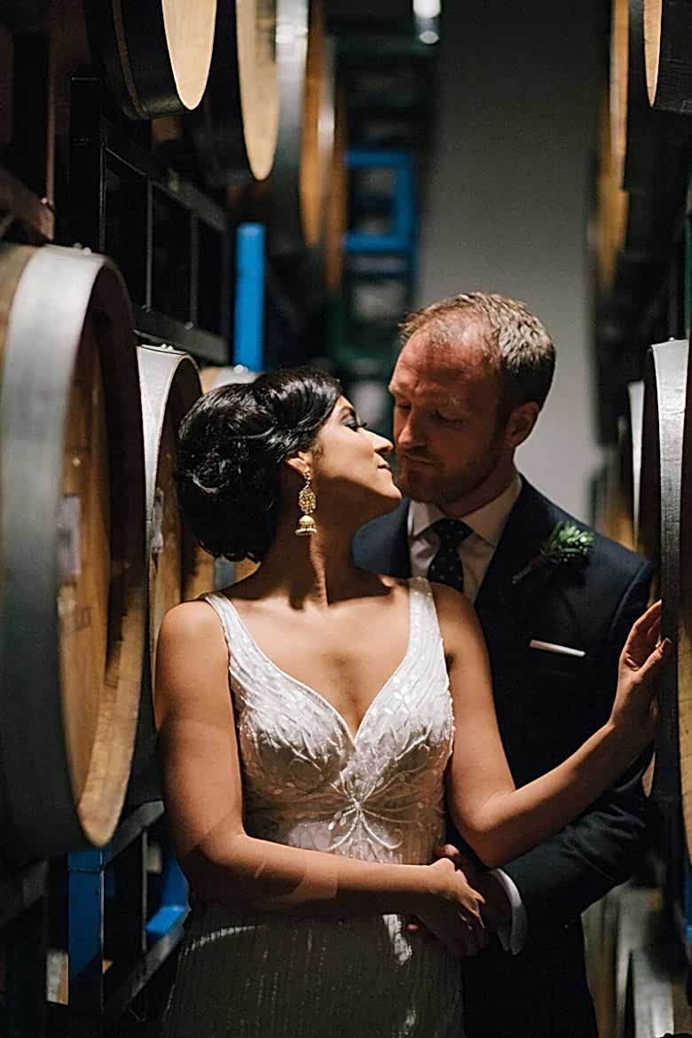 bride and groom with wine barrels