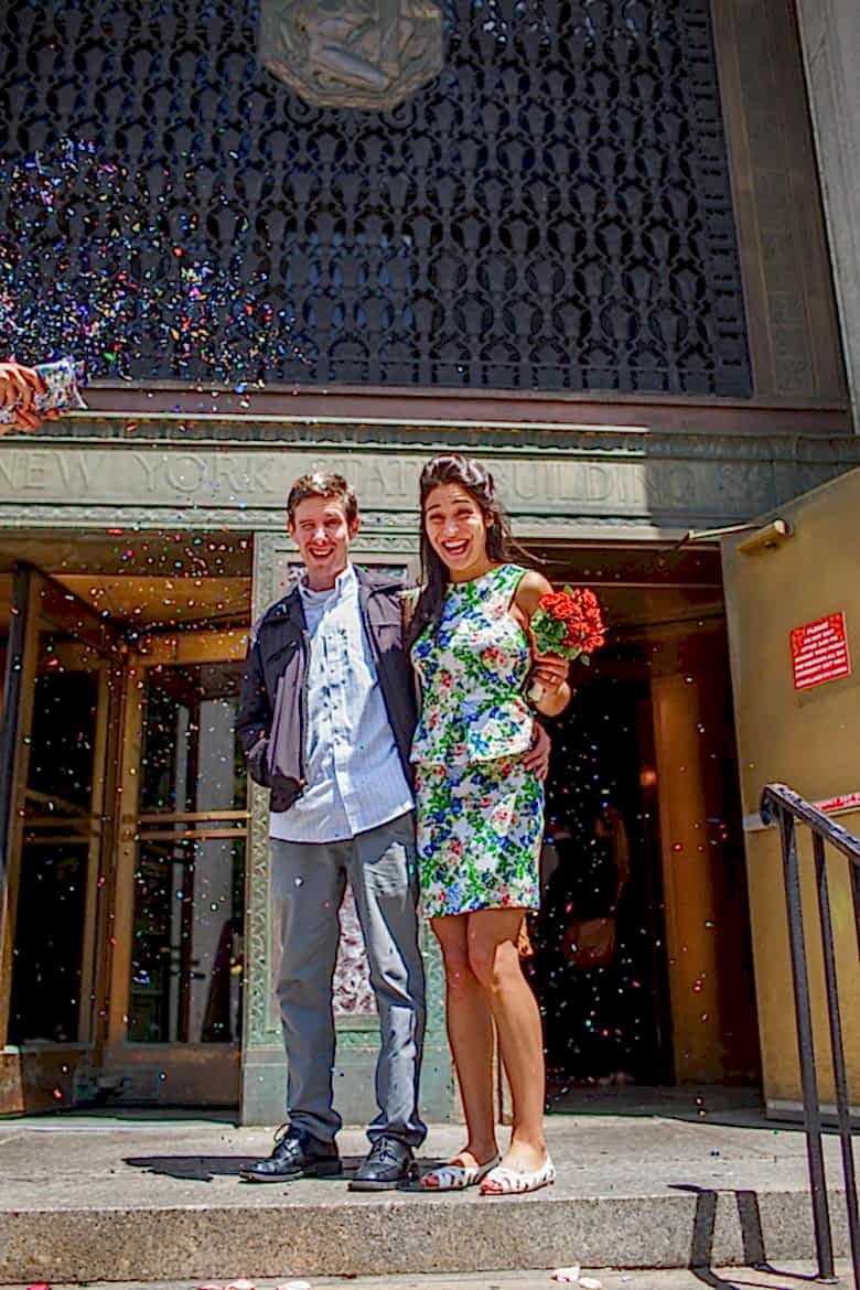 couple showered with confetti on steps of New York City Hall