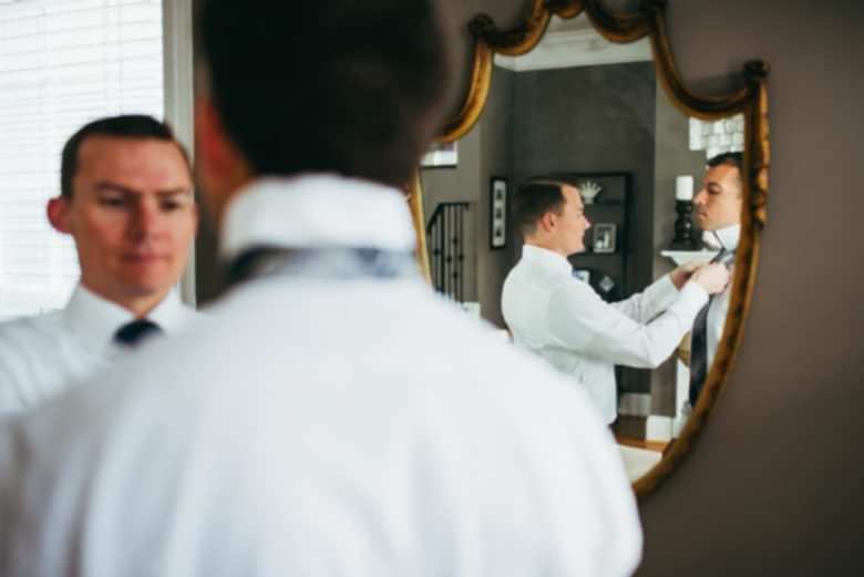 two men getting ready for wedding