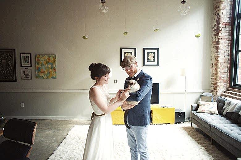 bride and groom in house with their dog