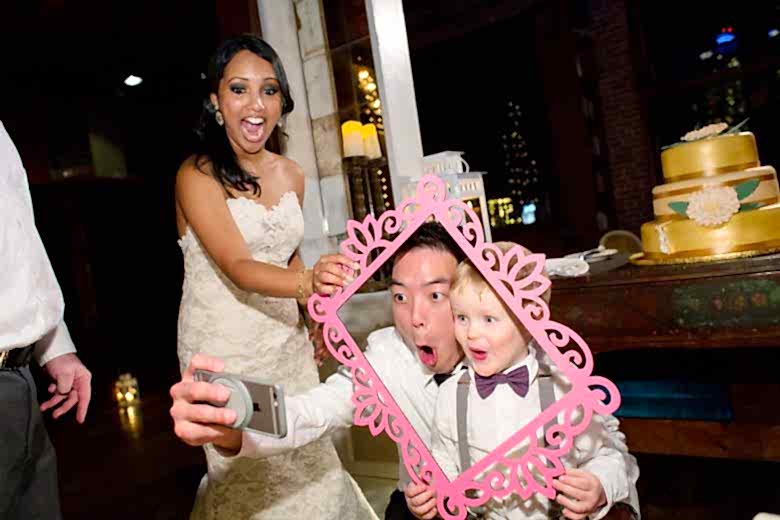 groom taking selfie with ring bearer