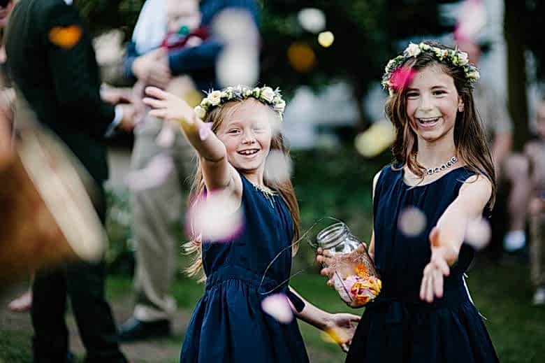 two flower girls throwing petals