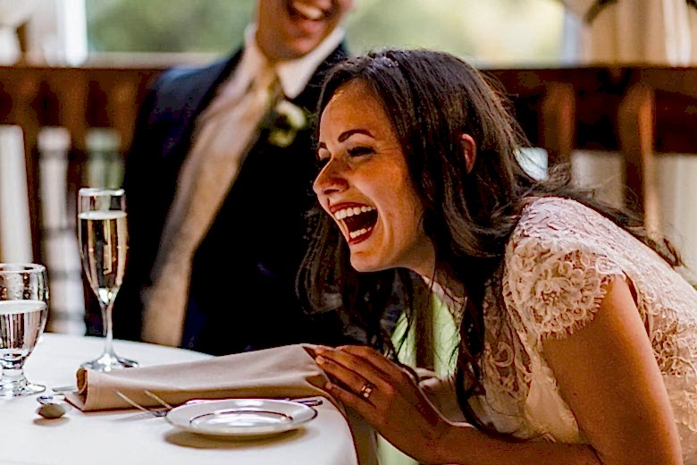 bride laughing during speeches