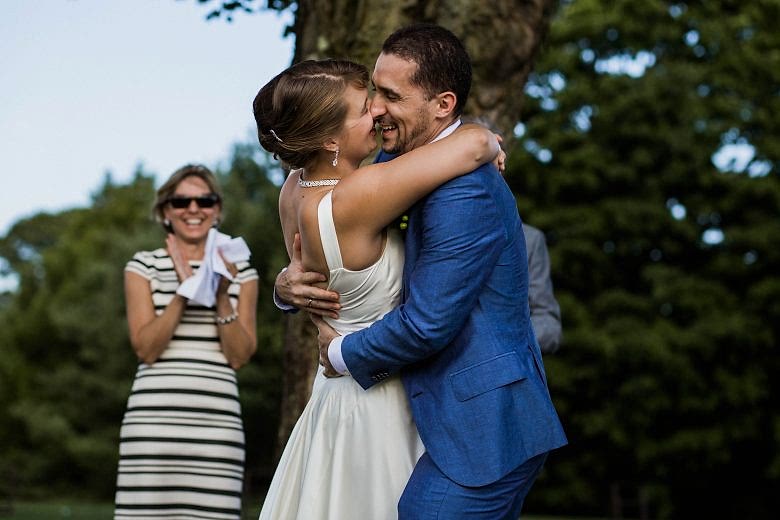 bride and groom laughing after their kiss