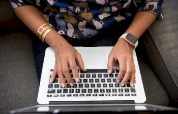 woman typing on her computer