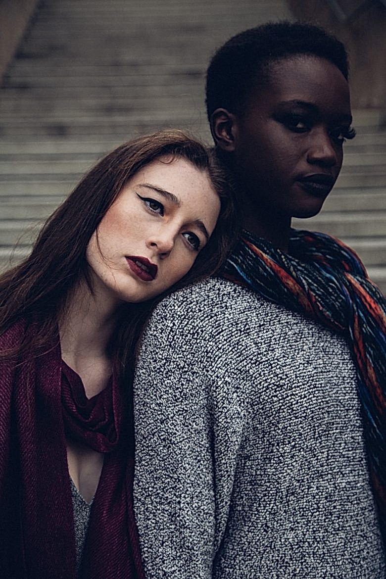 black woman and white woman standing together