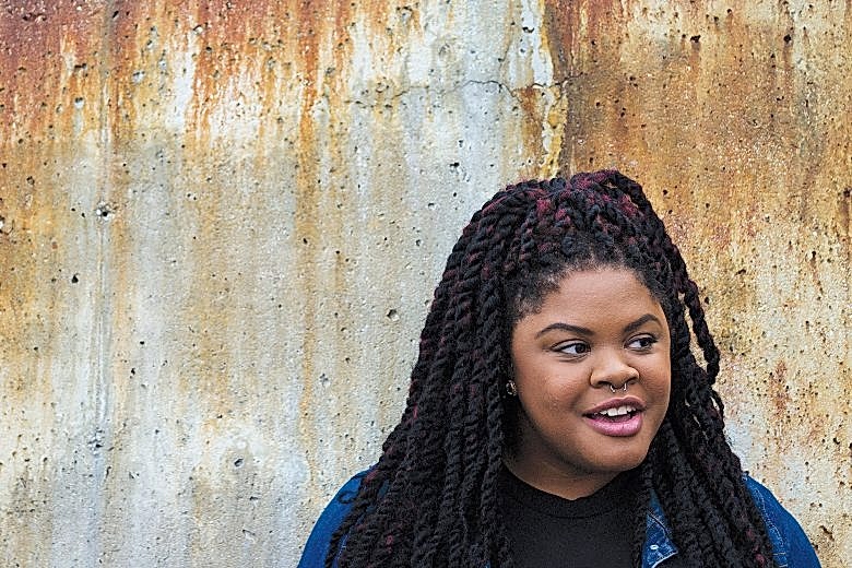 johnetta elzie standing against a wall