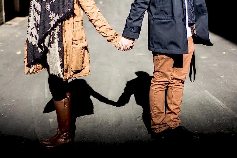 man and woman holding hands